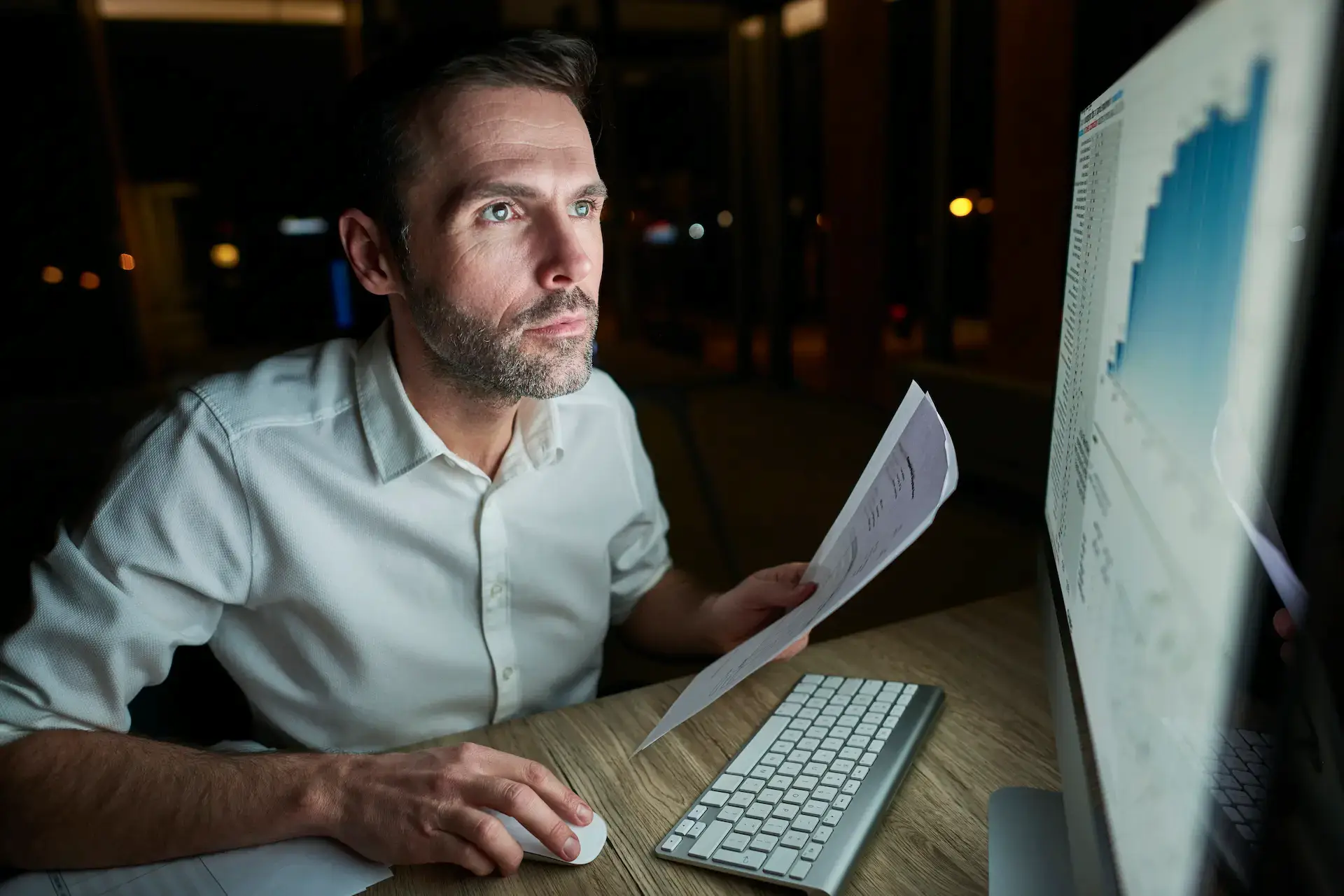 Man Holding Document Using Computer